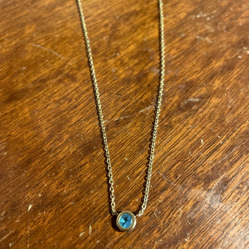 Michael Kors gold necklace with blue stone